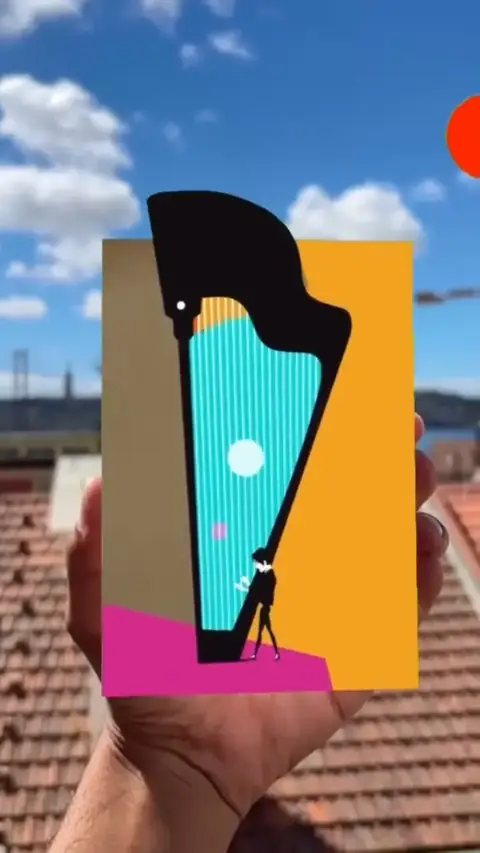 Amit Maoz's harp poster held up against a sky over rooftops; in augmented reality, coloured bubbles float up out of the harp