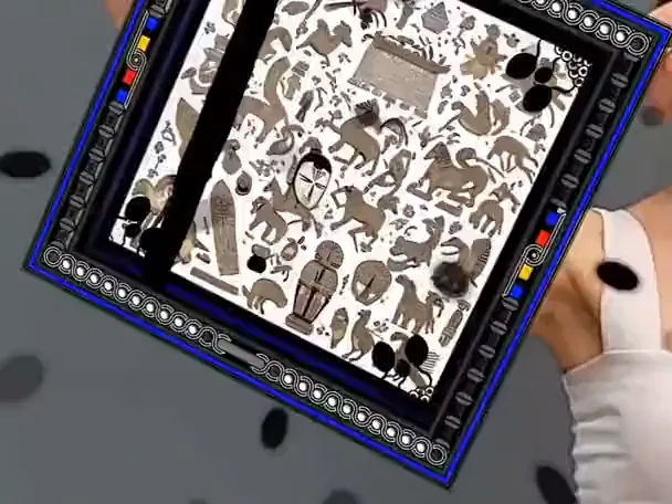 A printed silk scarf by Ahmet Rüstem Ekici whose blue and orange mandala pattern comes to life and turns in AR